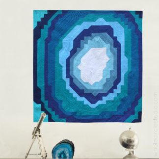 Stone Slice—a beginner friendly, easy quilt. Make it for a kid's room, budding geologist or rock / geode enthusiast! Instructions for 3 sizes: wall, quilt or queen quilt. Easy to assemble with fabric stripes and half square triangles (HSTs). Lots of diagrams and tips in the pattern!