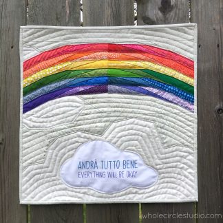 Andra Tutto Bene (Everything Will Be Okay), a free foundation paper piecing (FPP) pattern by Whole Circle Studio and Aurifil. Inspired by the words and beautiful artwork created by children in Italy during the Covid19 pandemic in 2020. While children and their families in Italy were quarantined in their homes, many displayed rainbow-themed banners and posters featuring the phrase "Andrà Tutto Bene" to send messages of hope and positivity. We encourage you to make this mini quilt to display in the window of your own home or sewing space. Make one for yourself, for a friend, or even for your local quilt shop. Share hope.