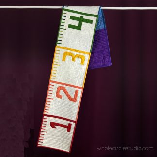 This 6' Ruler quilt is a cheeky reminder in this time of social distancing of what six feet (or 2 yards for us quilters!) looks like. Make this tape measure quilt/runner as a utilitarian decoration for display and use at your next socially distanced gathering. When not being used for a utilitarian purpose, it also makes a fun table or bed runner. Make one as a gift a tinkerer, teacher, kid, or baby as a wall hanging or growth chart.