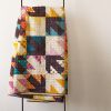 folded graphic quilt with arrow blocks on a quilt ladder