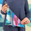 woman holding colorful zipper pouch