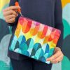 woman holding colorful zipper pouch