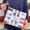 woman holding cute dog/cat themed zipper pouch