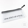 zipper pouch with phrase "One Stitch at a Time."