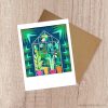 notecard with greenhouse art on the cover and a brown envelope