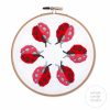 6 ladybugs in a circle embroidered inside a hoop