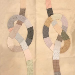 quilt block with neutral knots on a ivory background