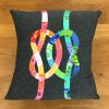 quilted pillow of two colorful interlocking knots