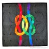 quilt with two colorful knots interlocking on a dark gray background