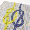 quilt top with yellow and purple knot interlocking on a gray print background
