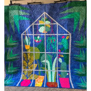 large modern greenhouse and plant quilt on a navy blue background