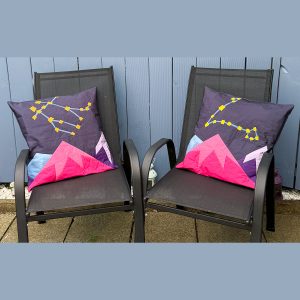 quilted pillow with star, constellation, and mountain quilt blocks