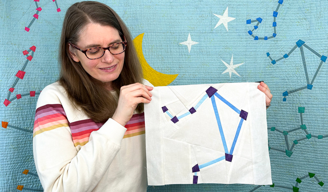 woman holding a Libra constellation zodiac star quilt block