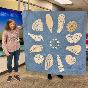Light blue and cream seashell quilt made with the Shoreline Shells Block of the Month pattern.