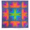modern, colorful quilt with sharp angle quilt blocks arrange in a rainbow color palette