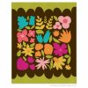 Colorful modern flower quilt blocks with bold contrast on a brown fabric background