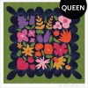 Colorful Wildflower Remix Queen quilt showing large floral quilt blocks on a navy blue background with a green border