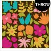 Bold, colorful flower Throw quilt on a brown background