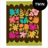 Colorful modern flower quilt blocks made into a Twin Size quilt on a brown background with a green border