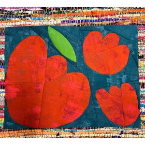 foundation paper pieced flower quilt block with red flowers on top of a colorful rug