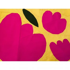 quilt block with bright pink flowers, green leaf, on a yellow background
