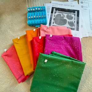 colorful fabrics, quilt pattern, and pins