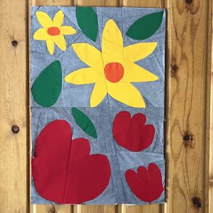 cute flower quilt blocks on a wood wall