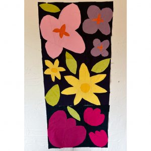 Paper pieced flower quilt blocks on a navy background