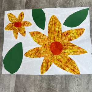 Colorful floral quilt block with bold fabric prints from a block of the month quilting project