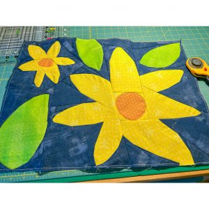 floral quilt foundation paper pieced quilt block on a work table