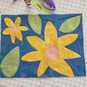 flower quilt block made by a quilter on a grid table