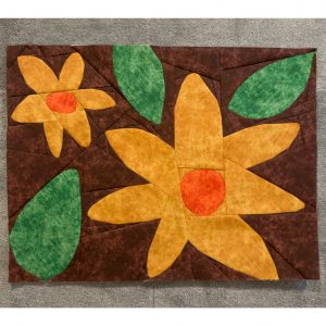 Paper pieced wildflower quilt block with bold, graphic design