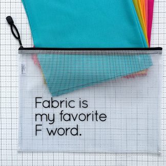Translucent waterproof vinyl project bag printed with “Fabric is my Favorite F Word.” with colorful fabric