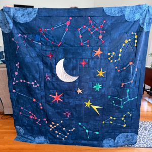 Finished Starry Signs quilt in rainbow color palette, foundation paper pieced stars and constellations, modern graphic throw quilt.