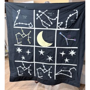 quilt made by foundation paper pieced zodiac constellations with names and birthdates of family members