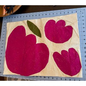 three foundation paper pieced flowers made using magenta speckled fabric