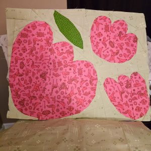 three foundation paper pieced flowers made using pink animal print fabric