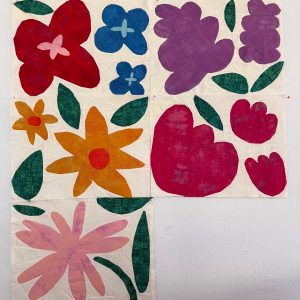 colorful flower quilt blocks made with grunge fabric on a white background