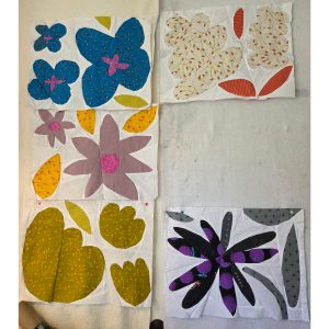 colorful flower quilt blocks made with floral fabric and scraps of white fabric