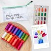 15 colorful spools of thread on a wooden plate, pouch that says Important Things Inside, thread booklet, and quilt pattern