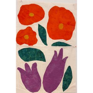 Two colorful quilt blocks and arranged on a design wall.
